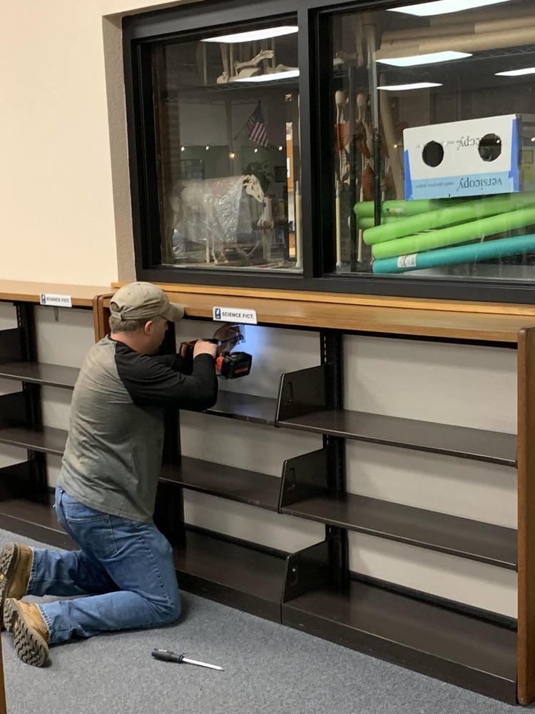 Aaron removing wall shelving units