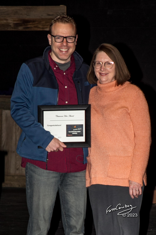 Mrs. Dutton receives award from Aaron Napier, VP of Programming and Community for Ad Astra Radio